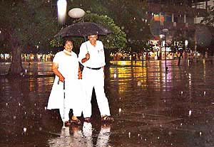 A couple enjoys the cool weather after a brief but heavy downpour lashed the city