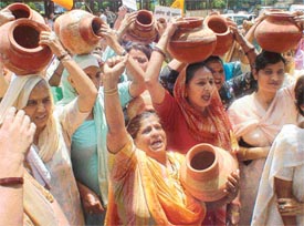 Activists of the BJP Mahila Morcha, carrying empty pitchers, protest against hike in water and sewerage charges at Clock Tower Chowk