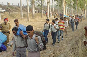 Surviving passengers being shifted away from the accident site