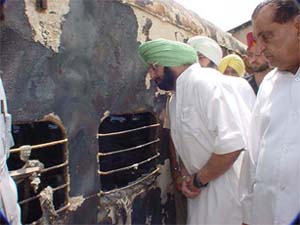 Punjab Chief Minister Capt Amarinder Singh takes a look inside a burnt bogie