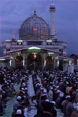 Kashmiri Muslims recite dusk prayers at the Hazratbal shrine 