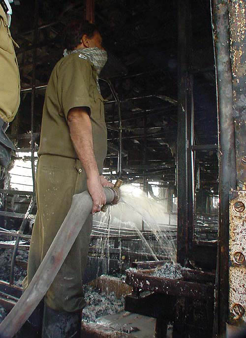 A fireman puts out the last of flames in a coach of the ill-fated train.