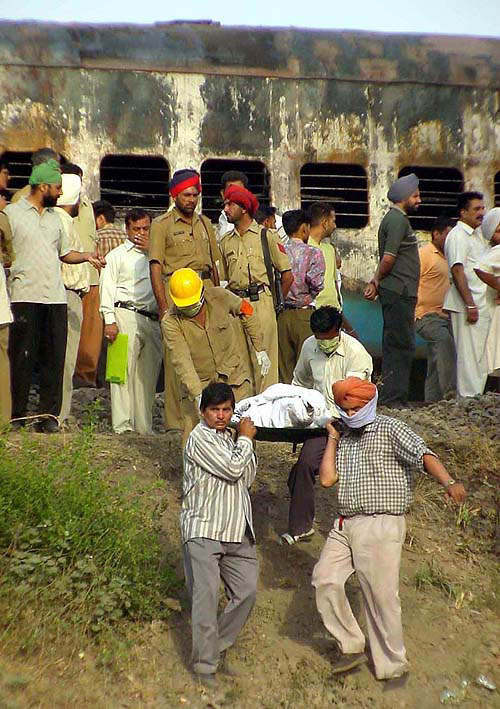 Rescue workers carry the body of a victim from the train.