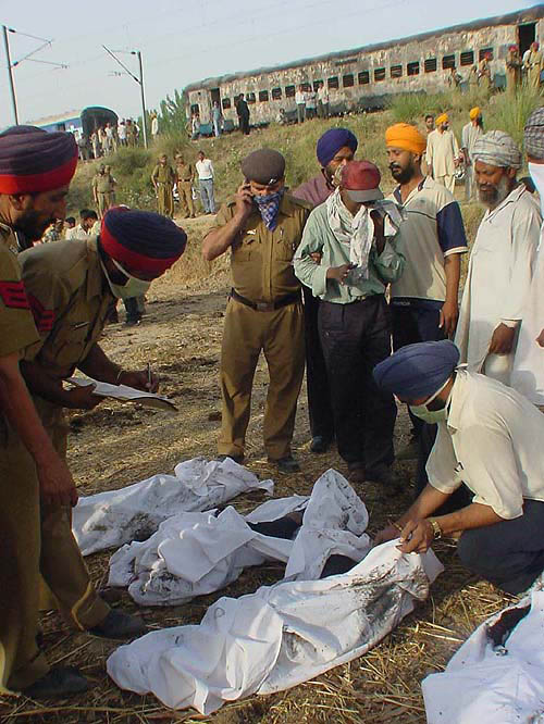Officials attempt identification of bodies at the mishap site.