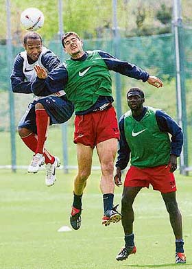 Arsenals Thierry Henry fights for the ball with team-mates Stathis Tavlaridis and Kolo Toure 