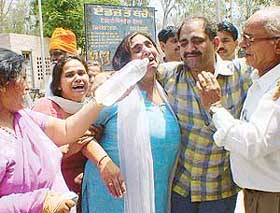 Kanchan Ranis mother being consoled by her relatives outside the Civil Hospital, Phillaur, on Saturday. 