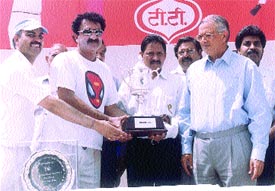 Lt-Governor Vijai Kapoor watches as the Veterans Cricket Championship trophy is presented to Haryana captain Rakesh Jolly by former Indian Test player Chetan Chauhan 