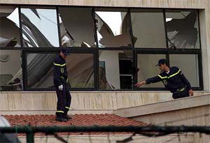 Moroccan fire-men check damages at the Spanish club that was hit by a suicide bomb attack in Casablanca