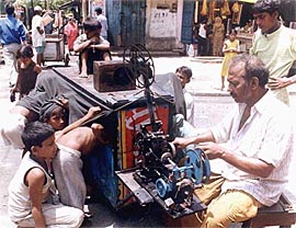 Mohammed Salim shows a 35-mm movie through his manually operated mobile celluloid projector