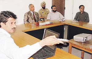Deputy Commissioner M. Ramshekhar gives a presentation to the Governor of Punjab and UT Administrator