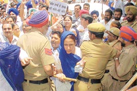 Workers of the Bharatiya Janata Party and Shiromani Akali Dal try to break the police cordon to enter the Mini-Secretariat