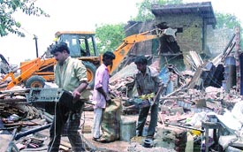 People collecting their belongings during the demolition by the MCD at Harijan Basti, Anand Parbat