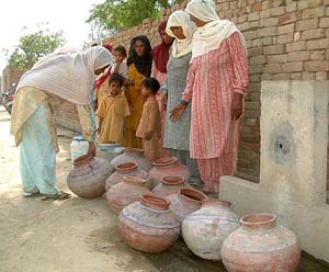 Women queue up for water at Kot Shamir village, near Bathinda, on Wednesday.