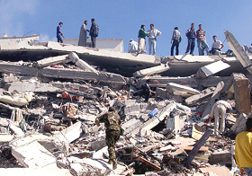 Rescue workers sift through the debris