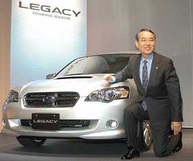 Kyoji Takenaka, president and CEO of Fuji Heavy Industries, poses with the Subaru automaker's all new Legacy