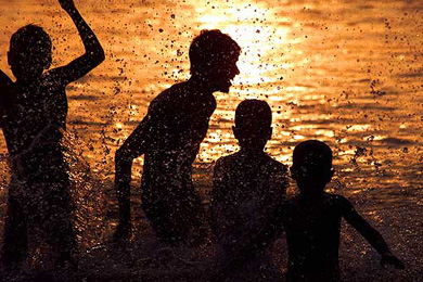 Children take a respite from the intense heat