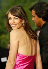 British actress Elizabeth Hurley poses with her companion Arun Nayar at Mougins 