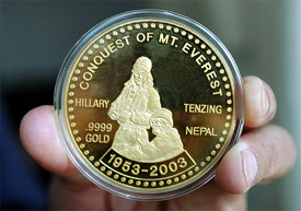 An officer at Nepal Mint Department displays the commemorative gold coin, jointly produced by Nepal and New Zealand