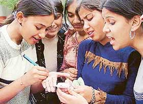 Students of class X see their results on a cell phone screen in Ludhiana on Saturday.