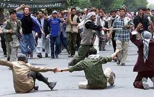 Angry Afghan men block a road near the US Embassy