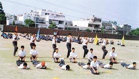 Students demonstrate yoga asans at the annual summer sports camp of Bharatiya Vidya Mandir School