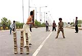 Children play cricket at the ITO (Yamuna) bridge