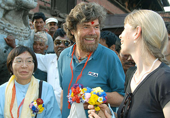 Junko Tabei of Japan, the first woman to climb Mount Everest, Reinhold Messner of Italy, the first person who reached the summit without the use of bottled oxygen and his wife smile during the Hanuman Dhoka Square Festival in Kathmandu