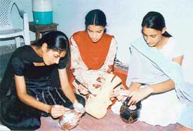 NSS volunteers participate in a pot-painting contest during a 10-day camp at Guru Nanak National College
