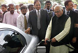 Minister for Petroleum and Natural Gas Ram Naik pumps petrol into a vehicle in Sri Lanka after the state-owned Indian Oil Corporation opened its first retail station in Colombo 