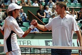 Flavio Saretta of Brazil shakes hands with Yevgeny Kafelnikov of Russia 