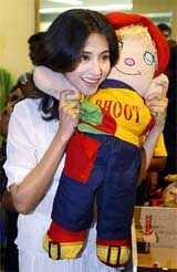 Bollywood actress Urmila Matondkar cuddles a soft toy