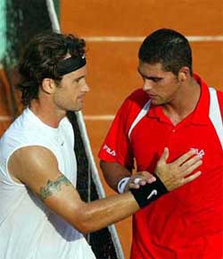 Spain's Carlos Moya has a nice gesture for Australia's Mark Philippoussis