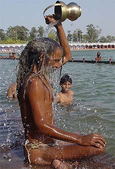 A sadhu takes bath in Brahm Sarovar