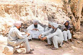 Relatives of Amrik Singh Rauni, the son of an Akali leader, who was murdered on Thursday, wait outside the mortuary 
