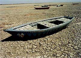 Fishing boats lie idly on the dried bed of the Nalsarovarbirdsanctuary due toshortage of rainfall