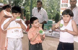 Children enjoy syrups at the Sherbet Festival in Dilli Haat