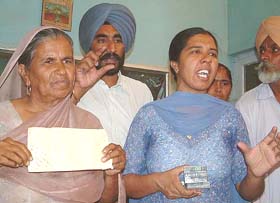 Ms Harpal Kaur, mother, and Ms Balwinder Kaur, sister, of Mr Napinder Singh at a press conference in Bathinda on Friday. 