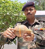 An Army man shows a camouflaged ammunition