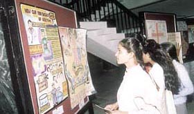 Students from medical and nursing colleges watching posters and cartoons.
