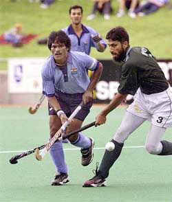 Indias captain Dhanraj Pillay and Pakistans Imran Tariq battle for the ball during their match