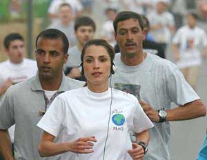 Jordan's Queen Rania wearing a "Peace" T-shirt runs in Amman
