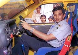 The lone Indian Formula One motor sports driver Narain Karthikeyan poses during a photocall