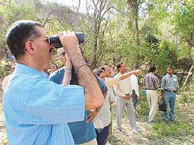 Mr D.S. Dhesi, Secretary, Forests, Haryana, watches birds at a forest near Berwala after inaugurating the Berwala Bird Safari