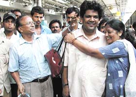 A passenger of the ill-fated Delhi-bound Magadh Vikramshila Express, which derailed near Buxer, being received by his parents after he reached safely at the Patna station on Sunday. 