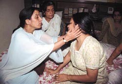 Relatives consoling each other at the GK-II residence of Harprakash Gupta, whose wife was found murdered.