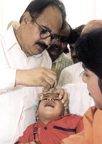 Delhi Health Minister Dr A.K. Walia giving polio drops to a child in the Capital on Sunday.