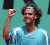 Gustavo Kuerten of Brazil reacts after winning his match against Gaston Gaudio of Argentia in the French Tennis Open at Roland Garros Stadium on Sunday. 