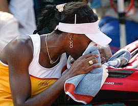 Venus Williams of the USA rests her head on her tennis bag