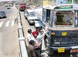 Employees of a private construction company argue with a truck driver coming from Mubarikpur village 