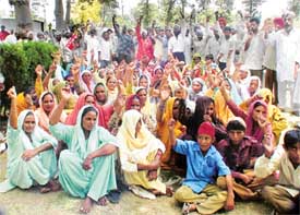 Families of sand mining workers protest against the hike in royalty outside the DC’s office